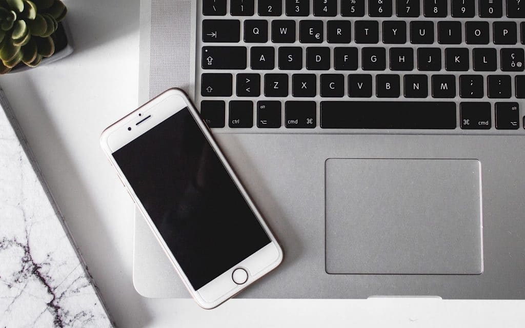 Phone and computer on a desk, working from home