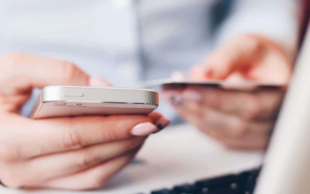 Someone looking at handing over credit card details using their phone