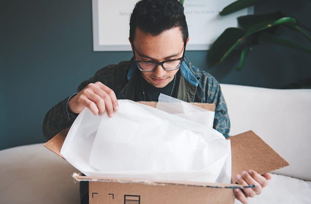 A guy opening a present