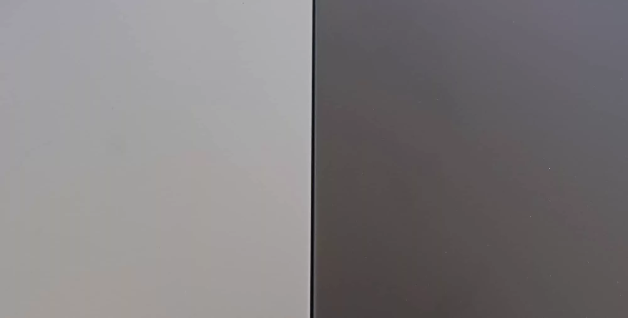 Apple's Space Grey MacBook Pro sitting next to a Space Black laptop. This is just a comparison between the colours, so you can see the differences.