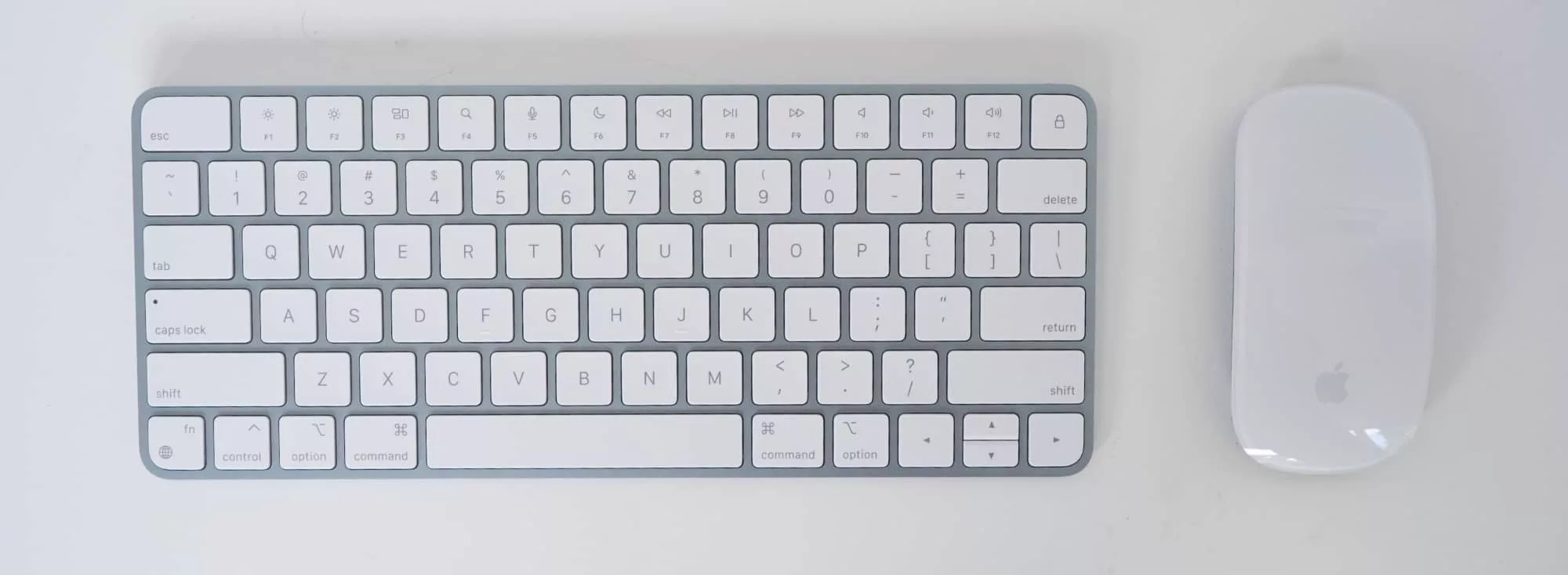 You can barely see it, but the keyboard is metallic blue like the Mac. So is the Magic Mouse, but only on the underside.