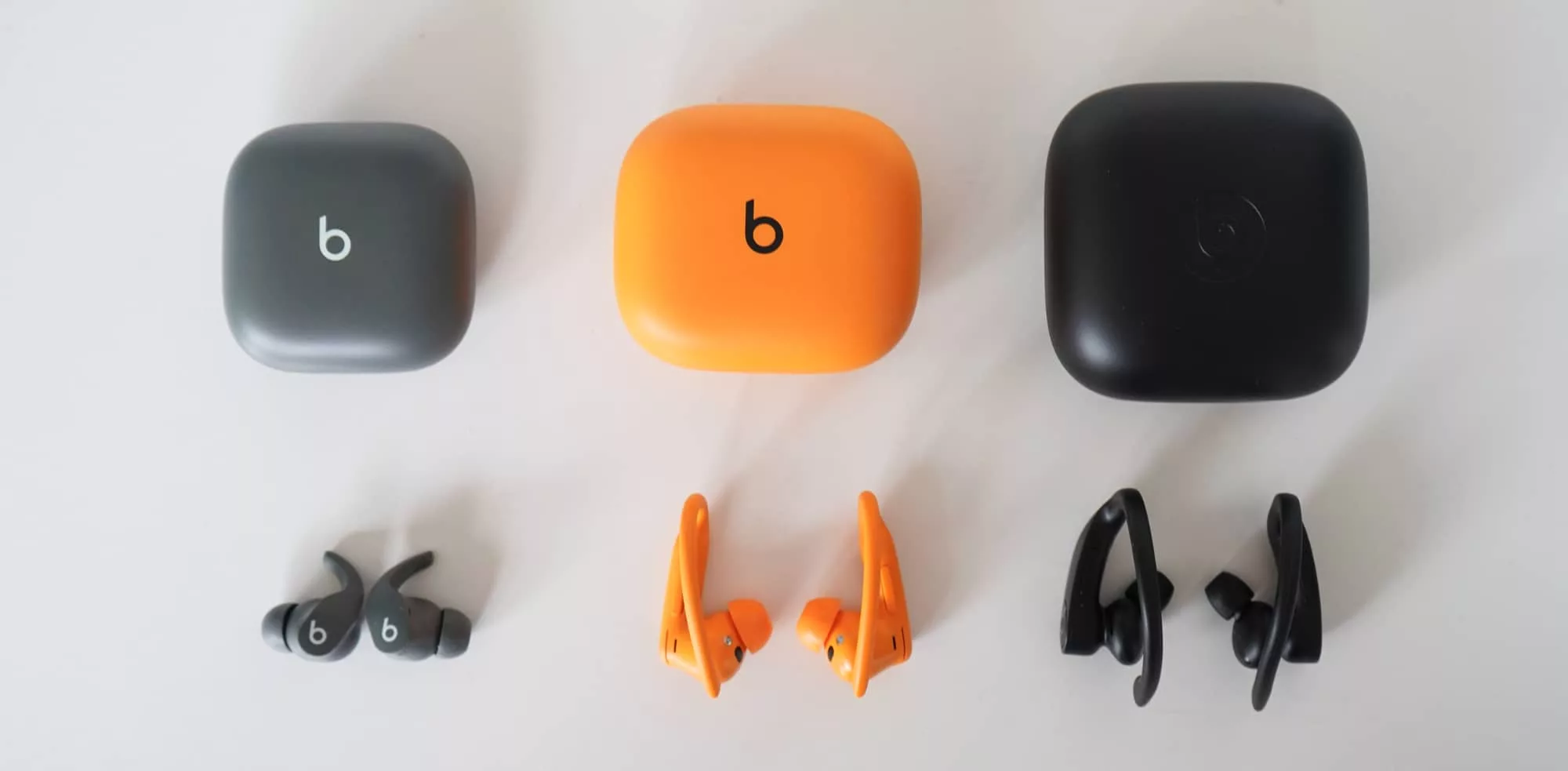 The Beats Fit Pro (left), next to the Powerbeats Pro 2 (middle) and the original Powerbeats Pro (right).