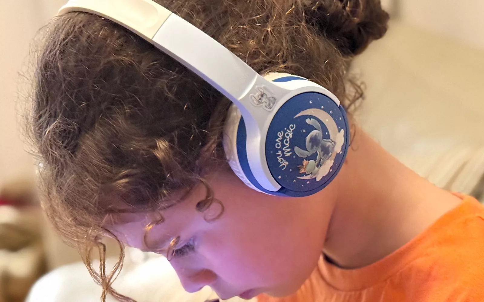 Ms 7 watches something wearing the Stitch Soundform Mini